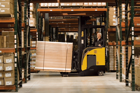 A Yale narrow aisle forklift transporting goods between pallet racks in a warehouse.